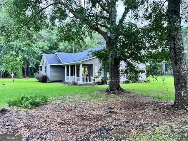 a view of a house with yard and a tree