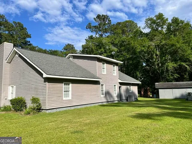 a front view of house with yard and green space