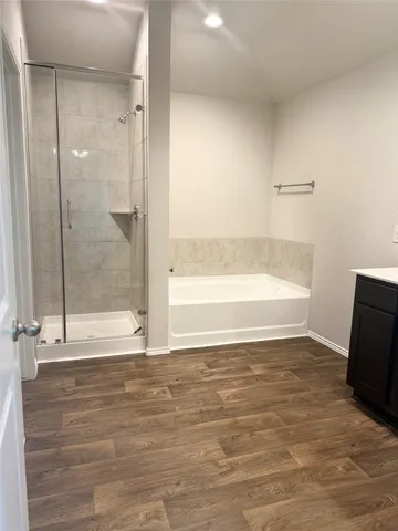 a view of a bathroom with a tub and shower