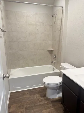 a white toilet sitting next to a bath tub