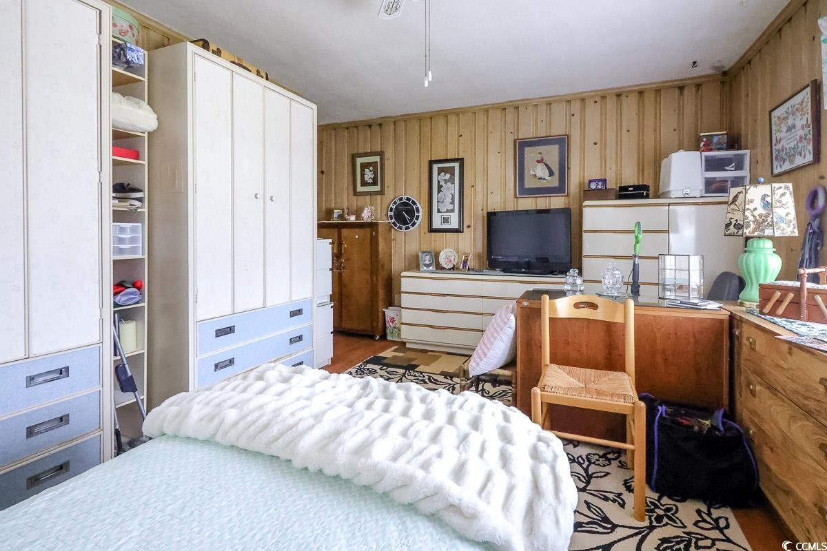 404 13th Avenue South Myrtle Beach, SC 29577 - Photo 17 of 39 Bedroom with wood walls