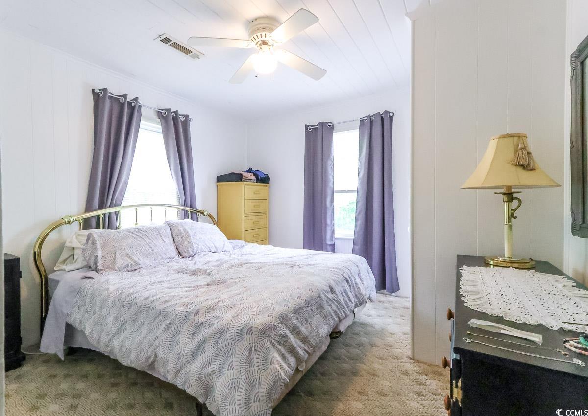 404 13th Avenue South Myrtle Beach, SC 29577 - Photo 35 of 39 Carpeted bedroom featuring multiple windows and a ceiling fan