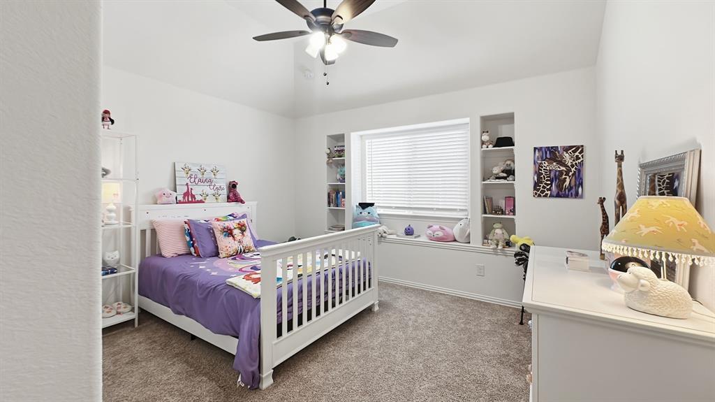 5216 Troupe Road McKinney, TX 75071 - Photo 31 of 40 Carpeted room featuring a ceiling fan, a window with blinds, and built-in shelving