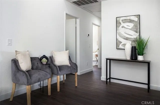 a view of a livingroom with furniture and a potted plant