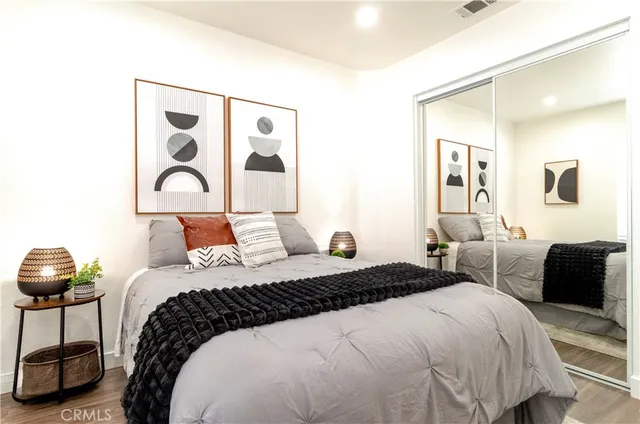 a bedroom with bed and a a large mirror