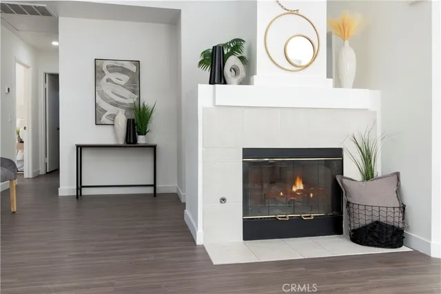 a view of a livingroom with a fireplace and wooden floor