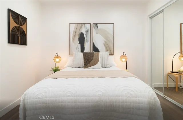 a bedroom with a bed and a flat screen tv