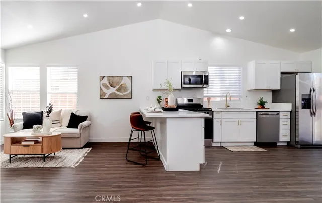 a kitchen with a sink cabinets and wooden floor