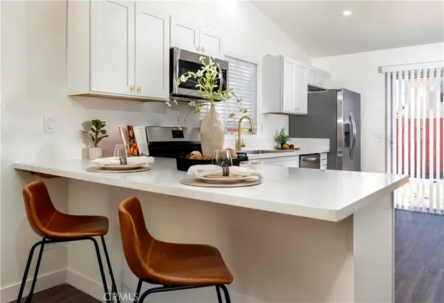 a kitchen with a table chairs and microwave