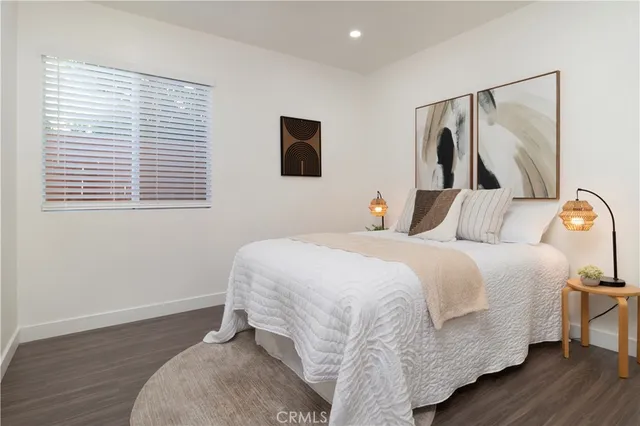 a bedroom with a bed and a painting on the wall