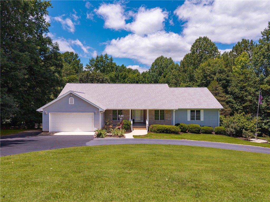 429 Burns Mill Road West Union, SC 29696 - Photo 38 of 49 A classic ranch home nestled among abundant greenery with a convenient attached garage.