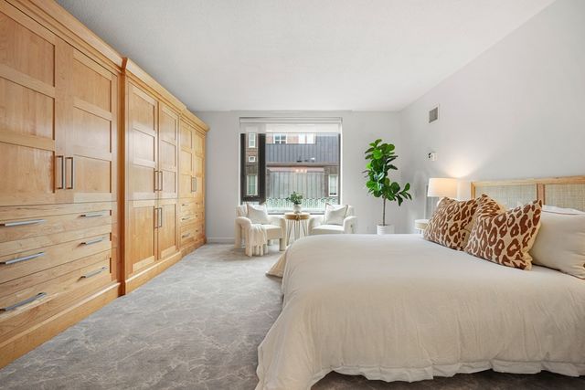 a spacious bedroom with a bed and a large window