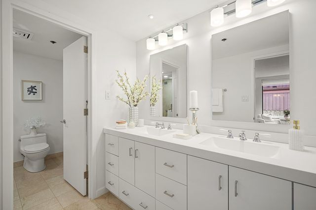 a bathroom with a double vanity sink and a mirror