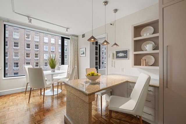 a dining room with furniture and wooden floor