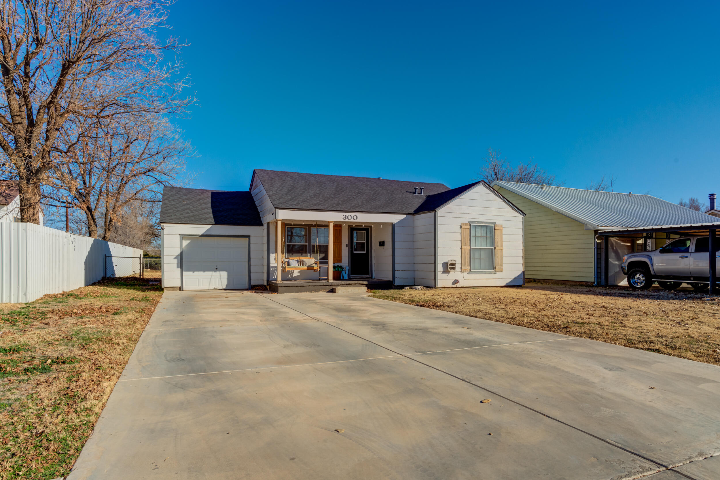 300 Aileen Street Plainview, TX 79072 - Photo 2 of 28 a front view of a house with a yard and garage