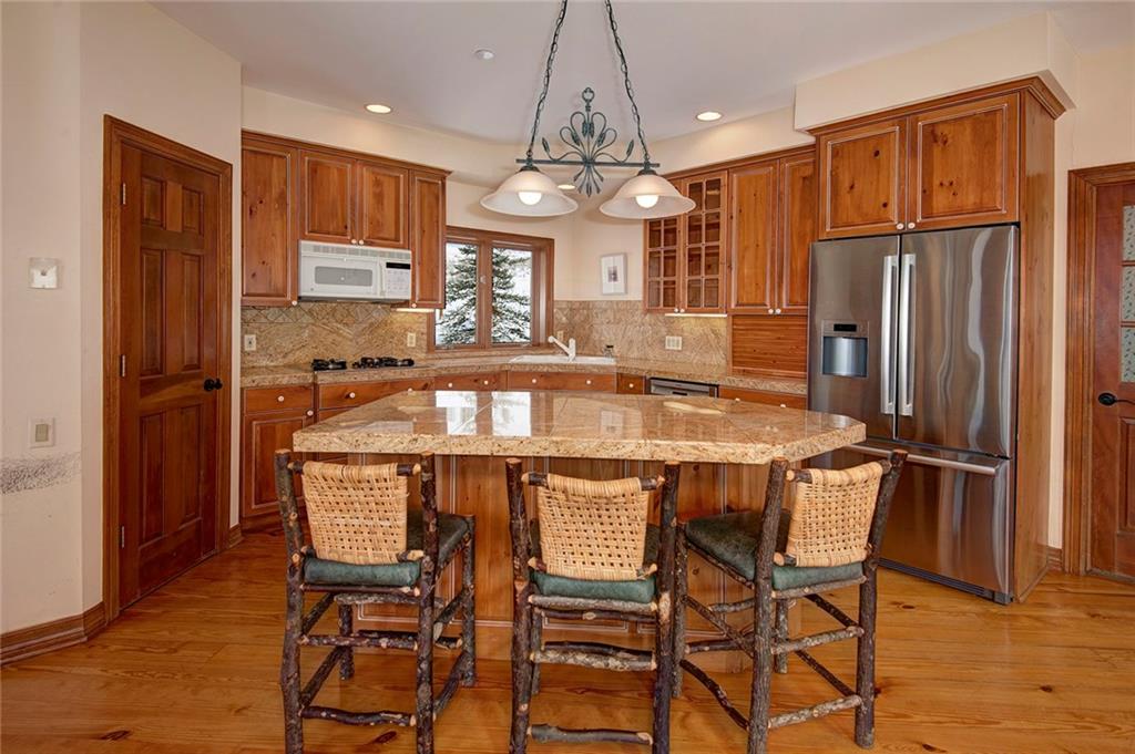 731 Pioneer Creek Road Silverthorne, CO 80498 - Photo 15 of 32 a dining table with chairs and wooden floor