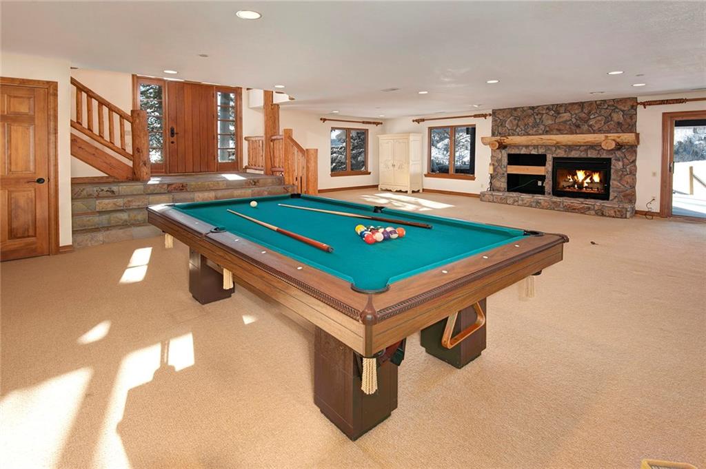 731 Pioneer Creek Road Silverthorne, CO 80498 - Photo 18 of 32 a room with pool table and a fireplace