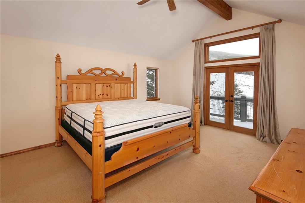731 Pioneer Creek Road Silverthorne, CO 80498 - Photo 25 of 32 a bedroom with a bed and a table