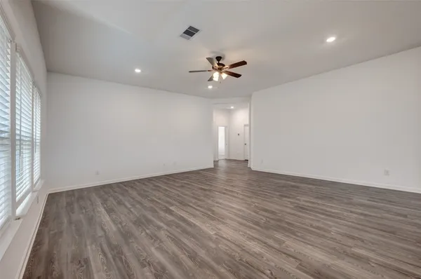 a kitchen with granite countertop a sink stainless steel appliances and white cabinets