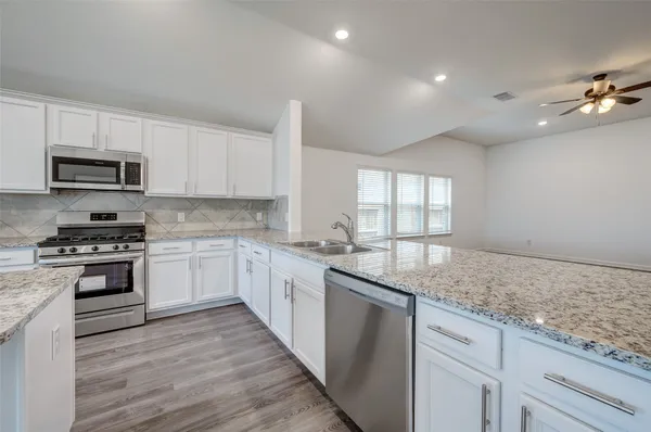 a view of kitchen with wooden floor