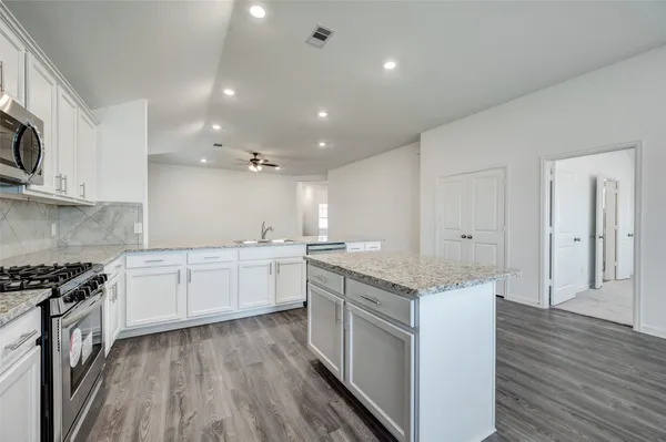 a bathroom with a shower sink and mirror