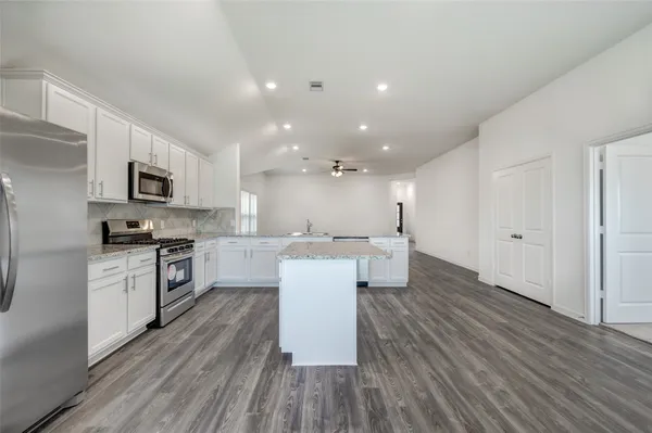 a spacious bathroom with a double vanity sink and a mirror