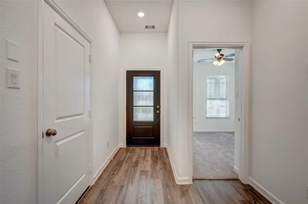 a view of a room with wooden floor and bathroom