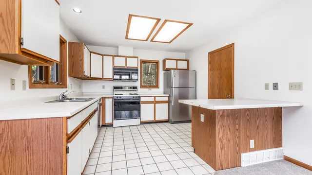 a kitchen with stainless steel appliances a sink and a stove