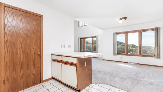 a view of kitchen with granite countertop cabinets and sink