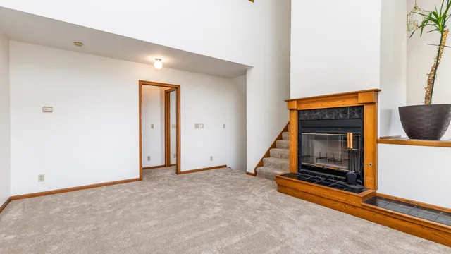 a view of an empty room with a fireplace