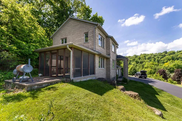 a view of a house with backyard and sitting area