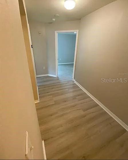 5455 Vineland Road, Unit 3108 Orlando, FL 32811 - Photo 14 of 17 an empty room with wooden floor and entrance