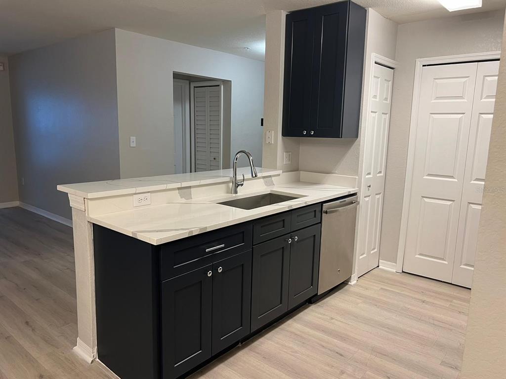 5455 Vineland Road, Unit 3108 Orlando, FL 32811 - Photo 2 of 17 a bathroom with a sink and a mirror