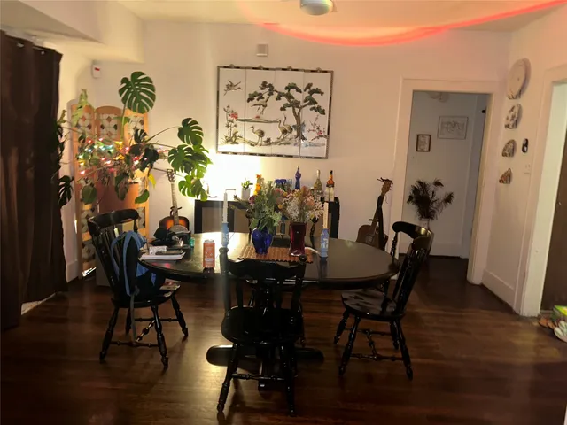 a view of a livingroom and dining room with furniture wooden floor and chandelier