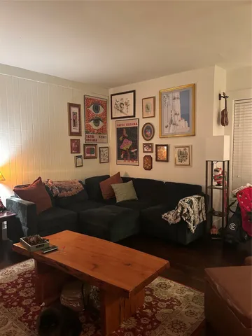 a view of a workspace with furniture and wooden floor