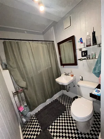 a dining room with furniture potted plants and wooden floor
