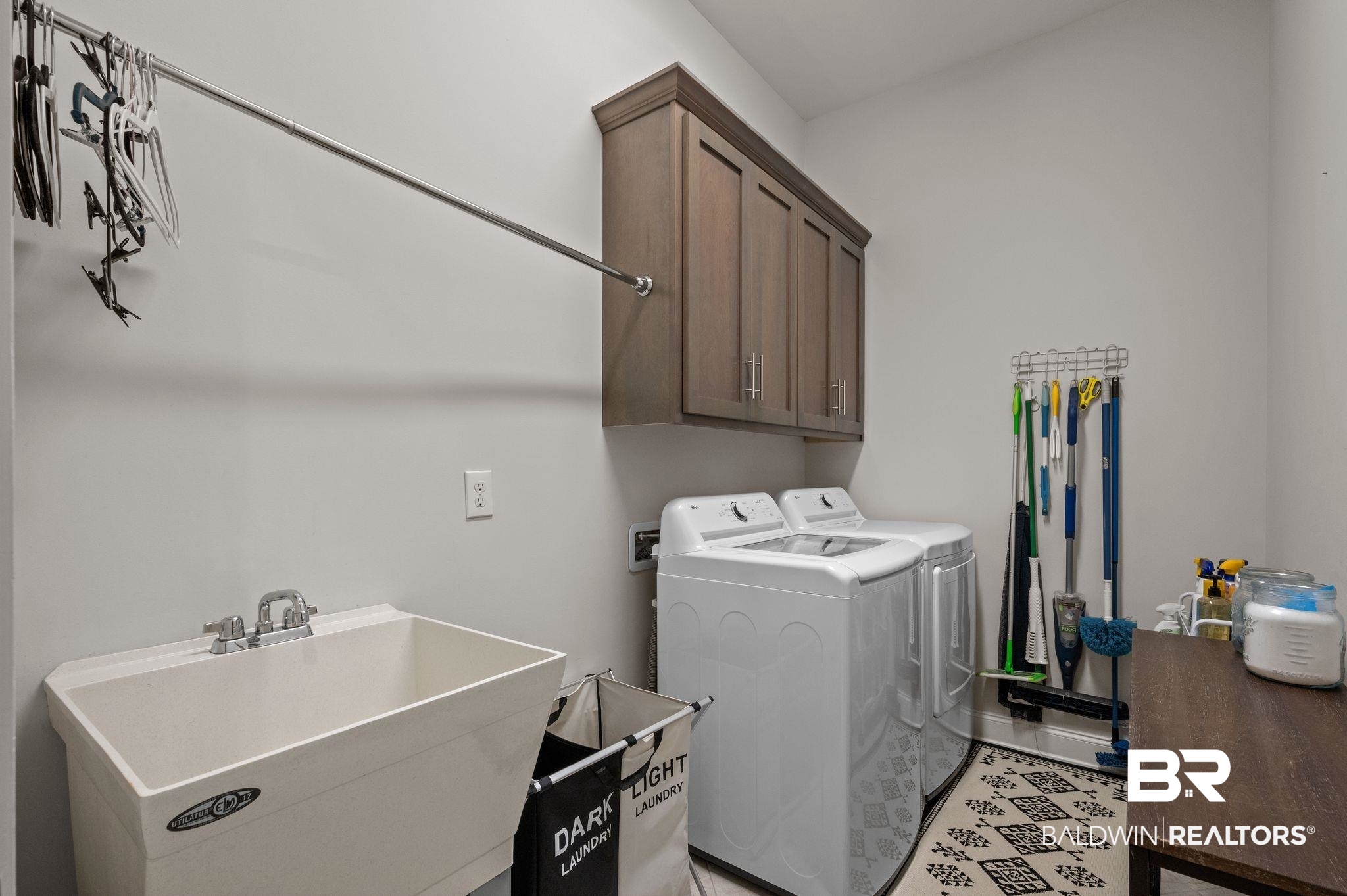 32194 Badger Court Daphne, AL 36527 - Photo 38 of 49 Laundry area with cabinet space and washing machine and dryer