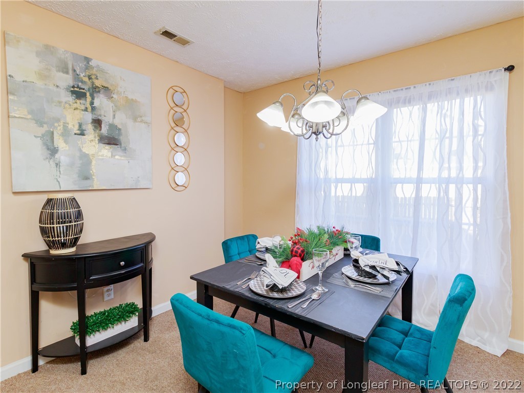 516 Kernstown Road Raeford, NC 28376 - Photo 9 of 20 a view of a dining room with furniture and a chandelier