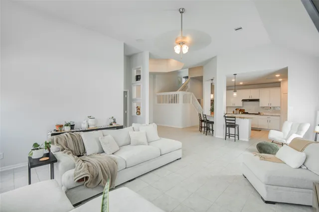 a living room with furniture and a chandelier