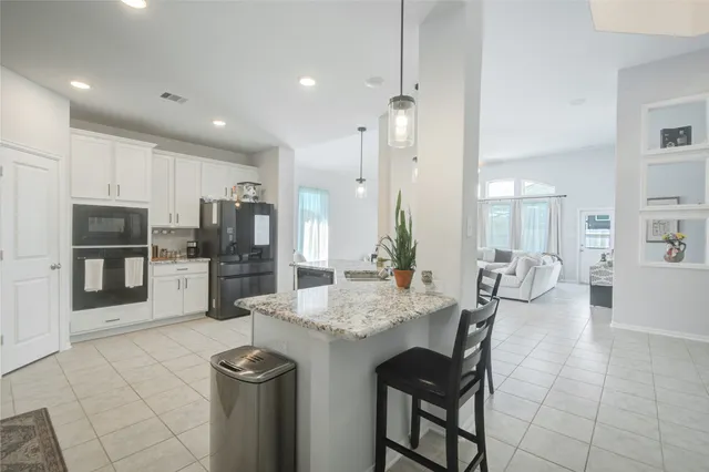a kitchen with refrigerator and cabinets