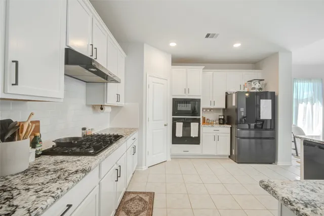 a kitchen with a sink stove and refrigerator