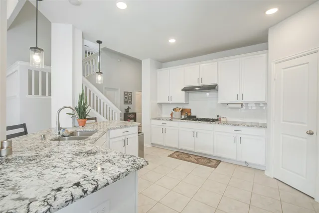 a kitchen with sink and cabinets