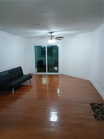 a view of livingroom with furniture wooden floor and window