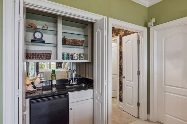 a bedroom with a bed a chair and a large window