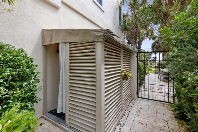 a view of a backyard with plants and a patio