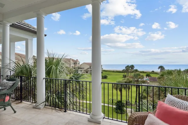 a view of a balcony with a floor to ceiling window next to a road