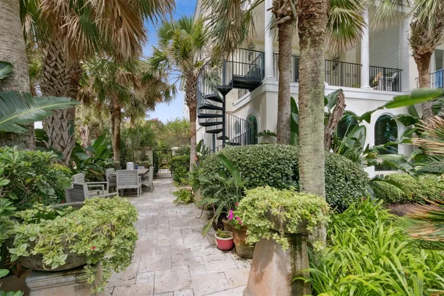 a view of a chair and table in the garden