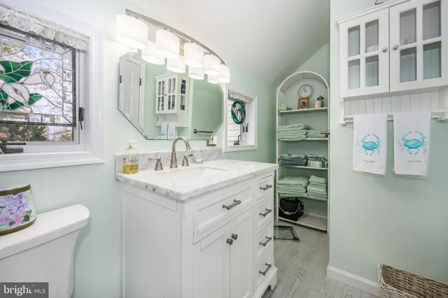 a bathroom with a sink a vanity and a mirror