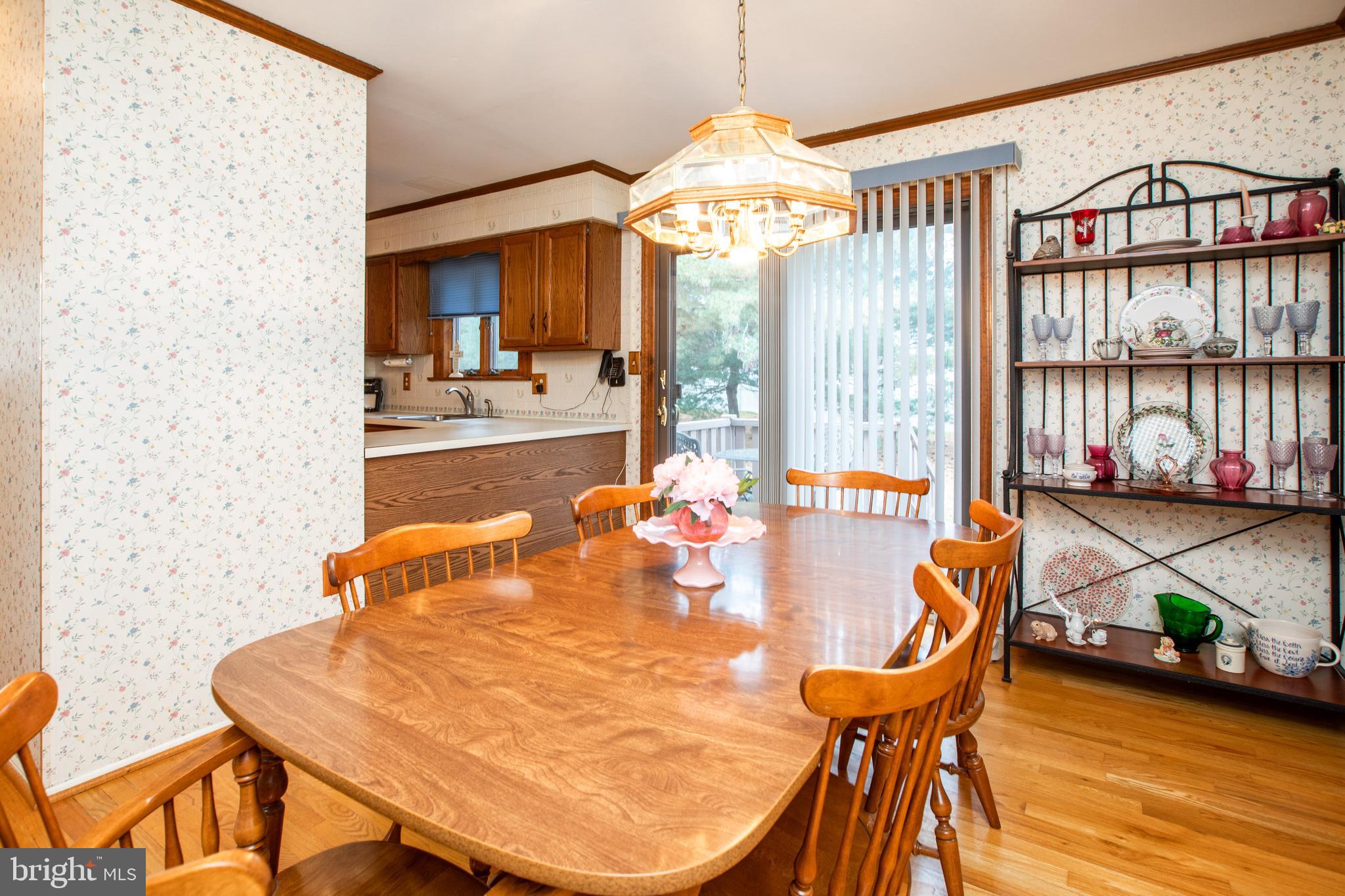 34 Kelly Court Hamilton, NJ 08690 - Photo 10 of 31 a view of a dining room with furniture a chandelier and wooden floor