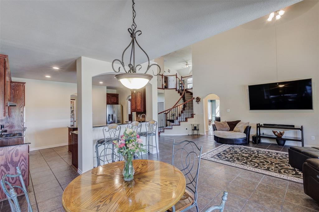 10414 Broadmoor Lane Rowlett, TX 75089 - Photo 10 of 38 Dining room with arched walkways, dark tile patterned flooring, a high ceiling, and recessed lighting